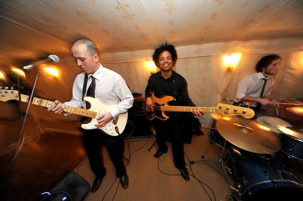 A live band playing for a private party inside a Jasmine lined boutique tent.
