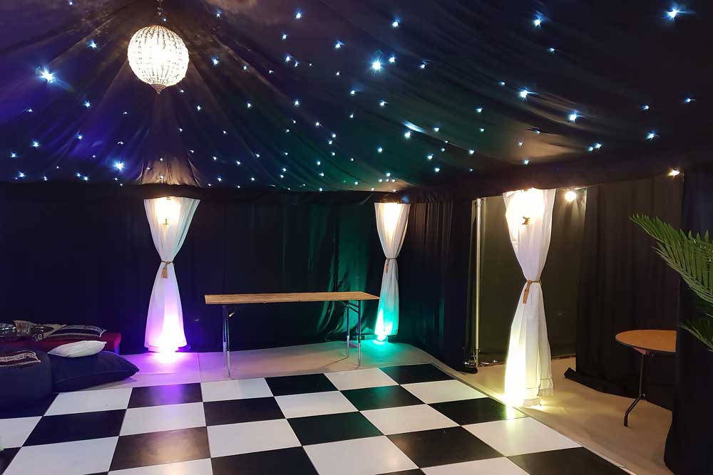 A 9x6m Night Club Marquee with Black and White Dancefloor and Colourful RGB uplights.