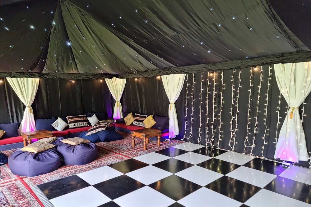 A 9x6m Arabian Tent with Starcloth Linings, Black and White Dancefloor and Low-Level Seating.