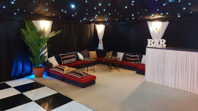 A starcloth lined party tent equiped with bar dancefloor and chillout furniture.