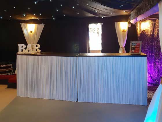 Two Bar Units with Pleated White Covers, Joined Together to Make a Large Bar for a 40th Birthday