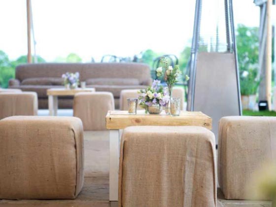 Hessian Cubed Pouffes Around a Small Pallet Table with White Legs