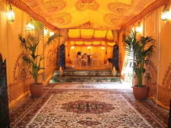 Cream persian rugs inside an Arabian marquee