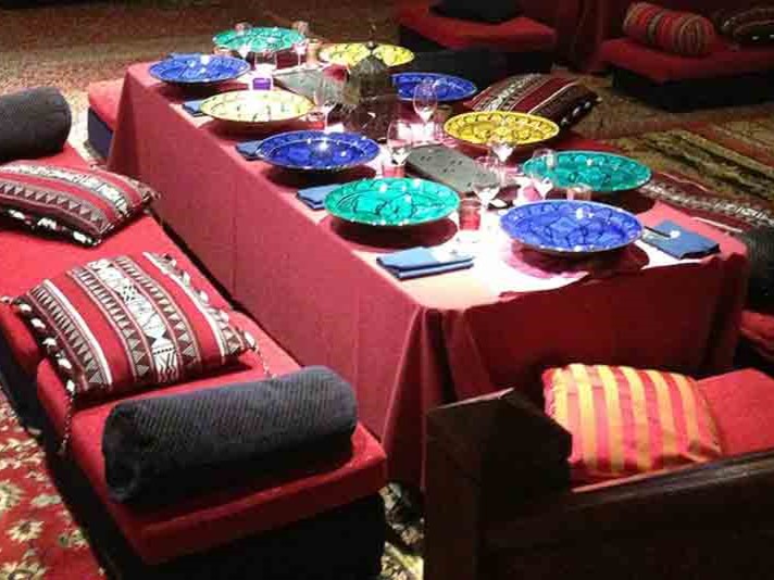 A Low-level Persian Banqueting Table with Floor Cushions and Moroccan Table Decorations
