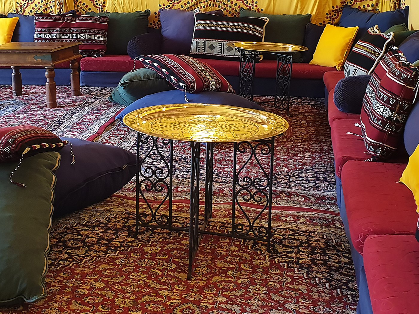 Polished Brass Table with Low-Level Cushions and Event Furniture in a Bedouin Tent