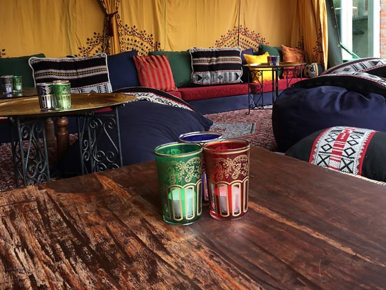 Colourful Moroccan Tea Glasses with Tea Light Candles Displayed as Table Decorations