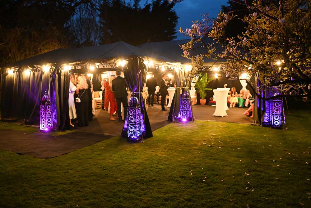1 meter high Moroccan candle lanterns, illuminating marquee exterior with RGB LED uplighters.