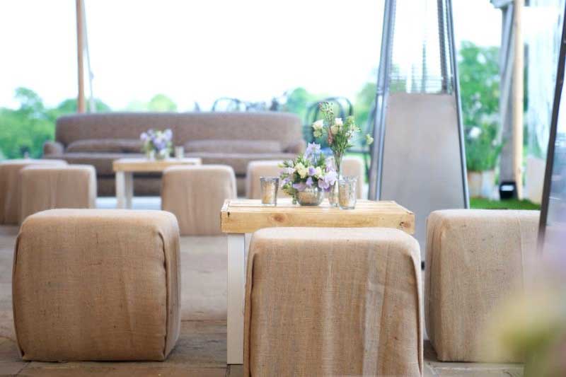 Rustic hessian wrapped cubed pouffes around a small pallet coffee table.
