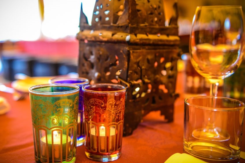 A selection of table decoration items including Moroccan tea glasses with t lite candles and Moroccan candle lanterns