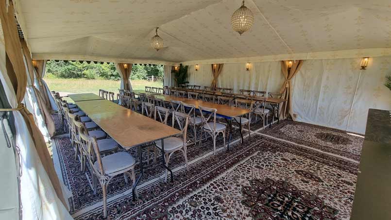 A rustic 6x9m marquee hired for dining at a festival wedding. 