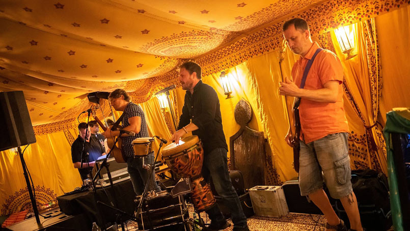 A band inside a Bedouin tent playing at an 18th Birthday party.