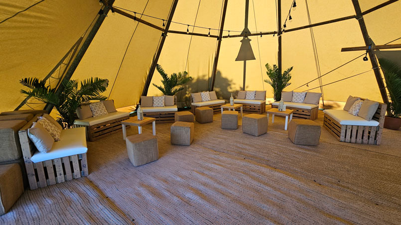 Pallet furniture inside a teepee at an Ibiza themed evening event.