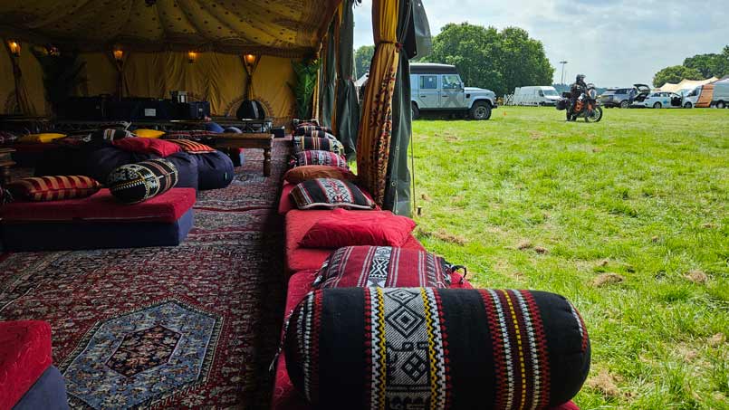 A motorcyclists outside of a festival tent.
