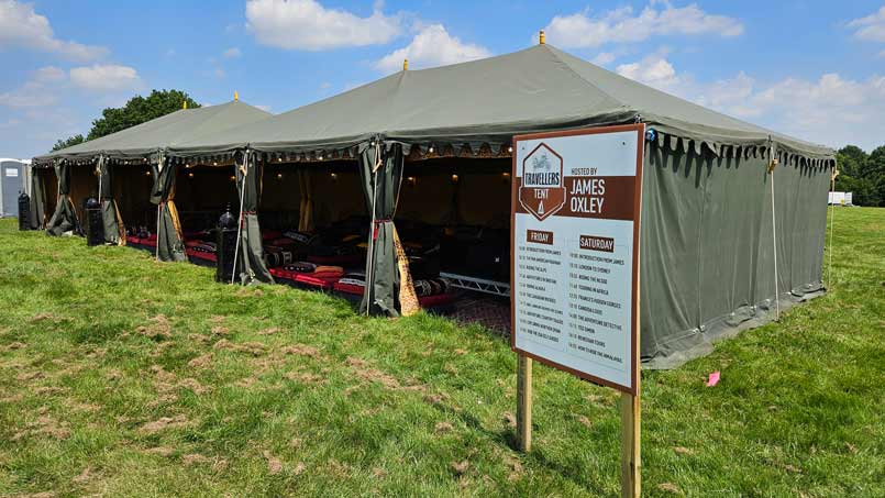 The travellers tent timetable sign outside of the speakers tent. Informing attendees what time each talk is due to begin.