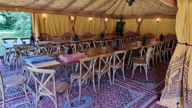 Formal dining furniture inside an Arabian tent.
